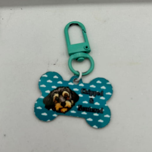 Personalised Pet Tag featuring custom cartoon dog illustration with and coloured clip